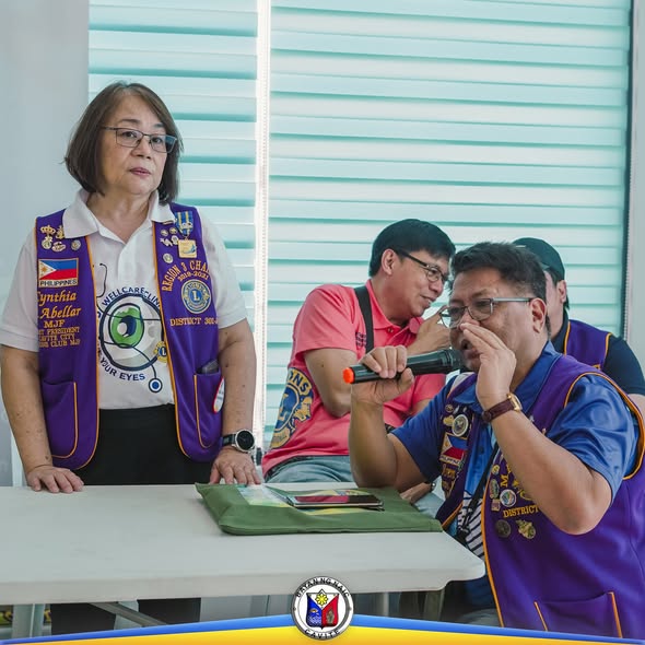 Mga miyembro ng Lions Club habang nagsasalita sa mikropono sa libreng eye check-up sa Naic