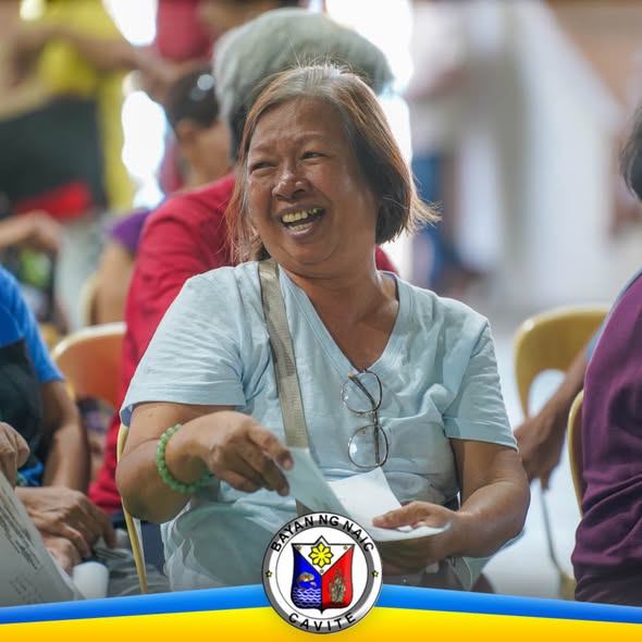 Nakangiting senior citizen habang tumatanggap ng social pension sa Naic, Cavite