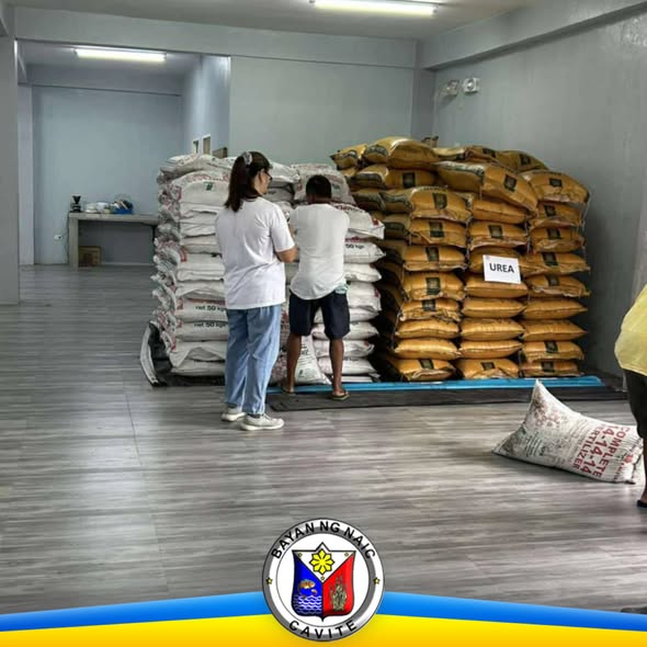Mga tauhan na nag-aayos ng mga sako ng abono sa bodega para sa pamamahagi sa mga magsasaka