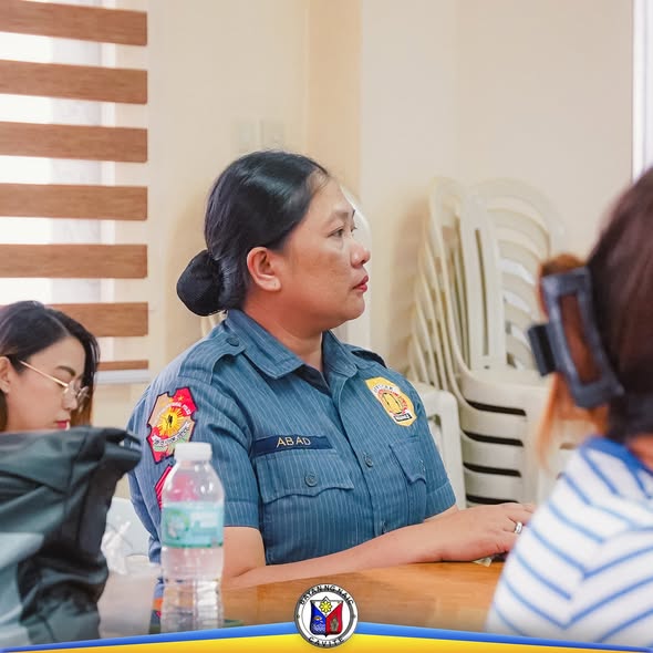 Babaeng naka-uniporme habang nakikinig sa pulong ng Local AIDS Council sa Naic