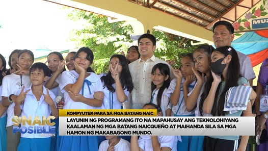 Mga estudyante at opisyal habang nagpapa-picture sa covered walkway ng paaralan, may banner sa likod
