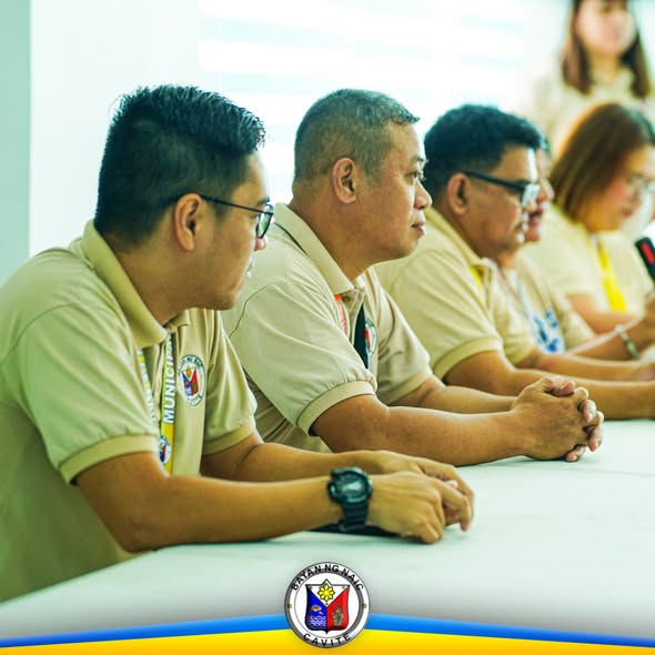 Mga kalahok sa Food Bazaar Orientation na nakaupo sa mahabang mesa at nakikinig sa programa sa Triple 8 Building