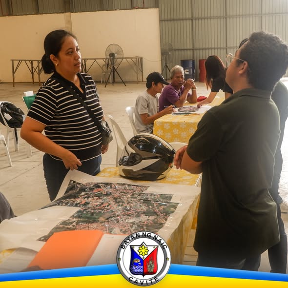 Mga kalahok at kawani sa pagpupulong ng PALIGID Program, may mapa ng lugar na nakalatag sa mesa sa Naic