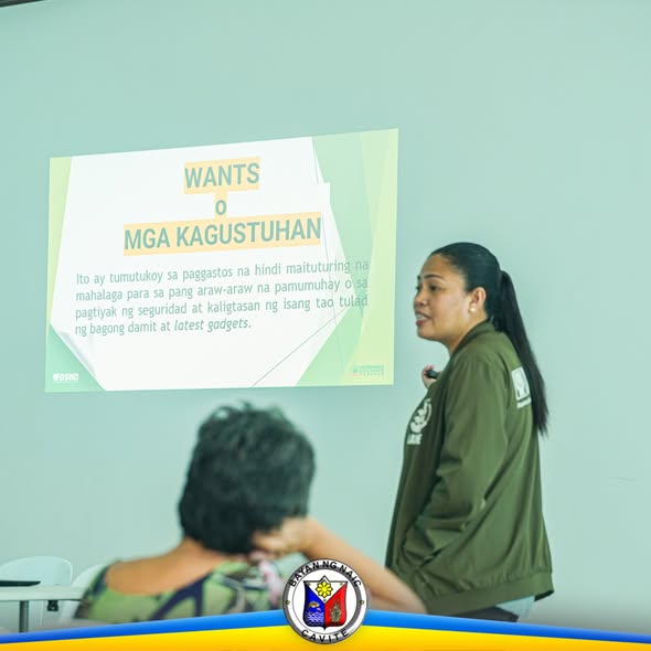 Babaeng nagpapaliwanag sa training tungkol sa 'Wants o Mga Kagustuhan' habang may nakikinig sa harapan