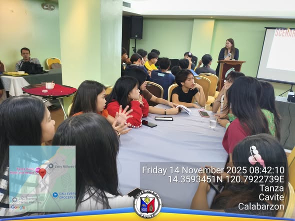 Mga kalahok na nag-uusap sa paligid ng bilog na mesa habang may nagsasalita sa podium sa training ng child leaders
