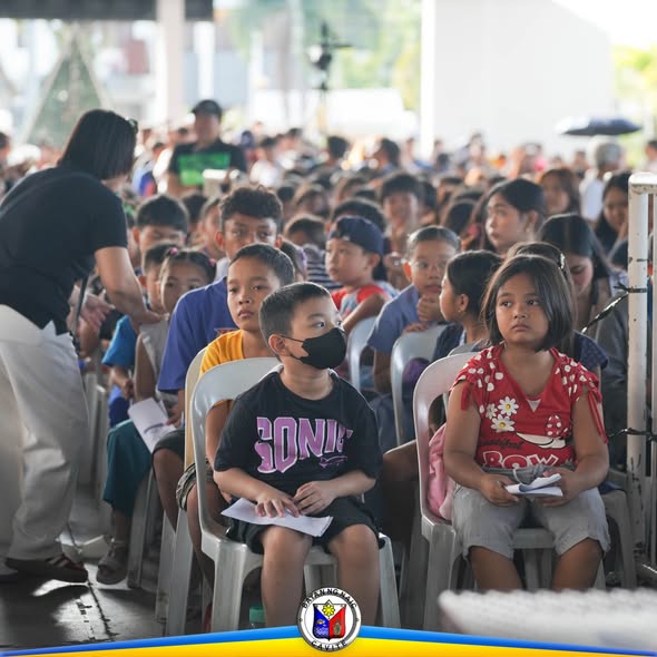 Mga batang nakaupo sa silya habang nakikinig sa State of the Children's Address sa Naic