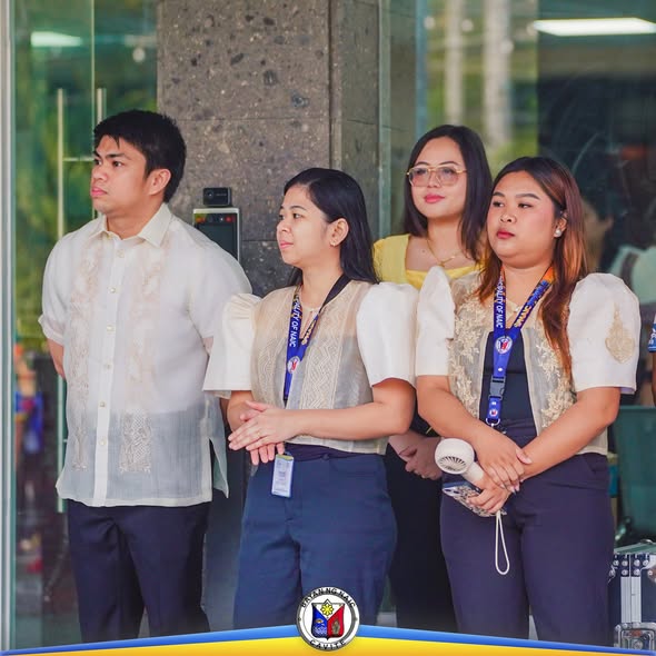 Mga kawani ng Naic Municipal Hall na nakatayo sa labas ng gusali habang isinasagawa ang flag raising ceremony