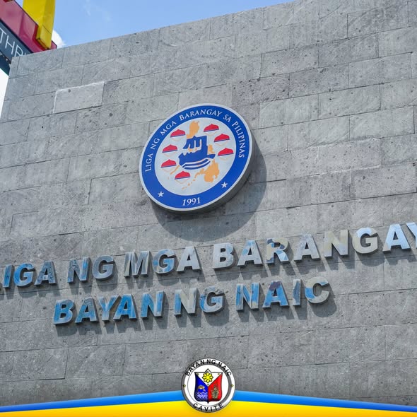 Logo at letra ng Liga ng mga Barangay, Bayan ng Naic, sa pader ng gusali