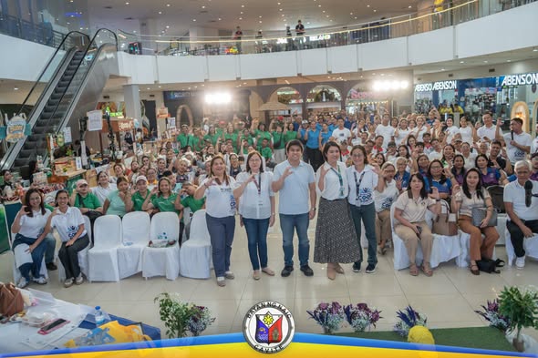 Mga kalahok ng Municipal Cooperative Month Kick-Off Celebration 2026 na nagpose sa atrium ng mall sa Naic