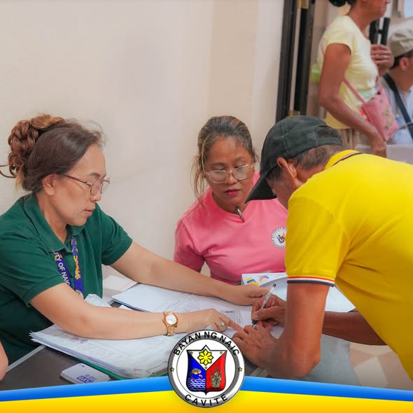 Mga kawani ng MSWD na nagproproseso ng dokumento habang pumipirma ang isang senior citizen sa OSCA Office, Naic