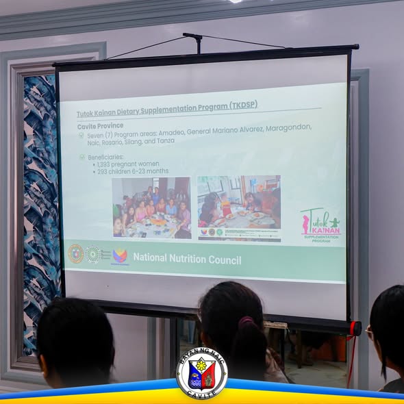 Presentasyon sa Tutok Kainan Dietary Supplementation Program sa screen habang nanonood ang mga dumalo