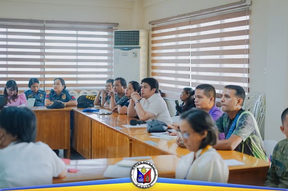 Mga kalahok sa Third Joint MPOC-MADAC-MTF-ELCAC Meeting na nakaupo at nakikinig sa ABC Hall, Naic