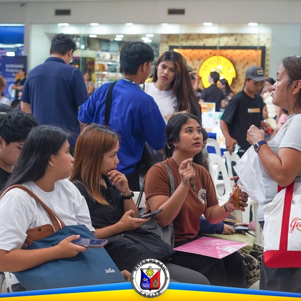 Mga tao sa Job Fair 2026 sa Naic, nakaupo at nakikipag-usap sa loob ng mall