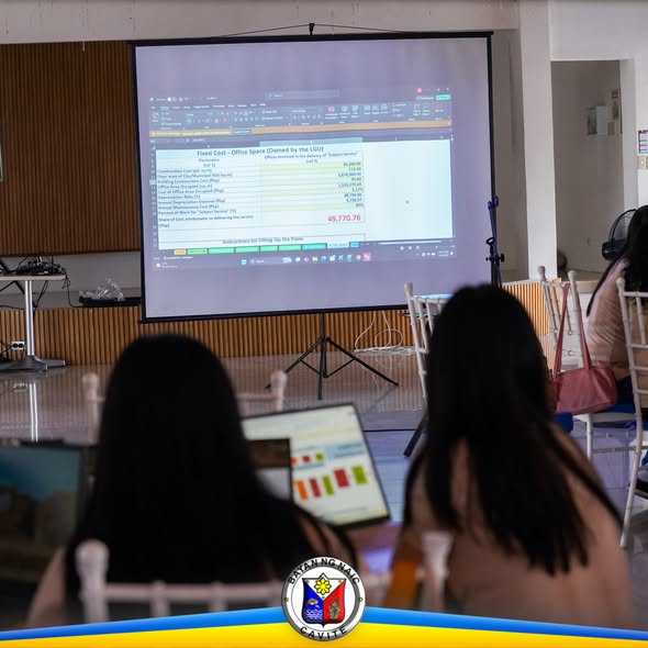 Mga kalahok sa Revenue Code Seminar na nanonood ng presentasyon sa screen habang may laptop, Sabang, Naic