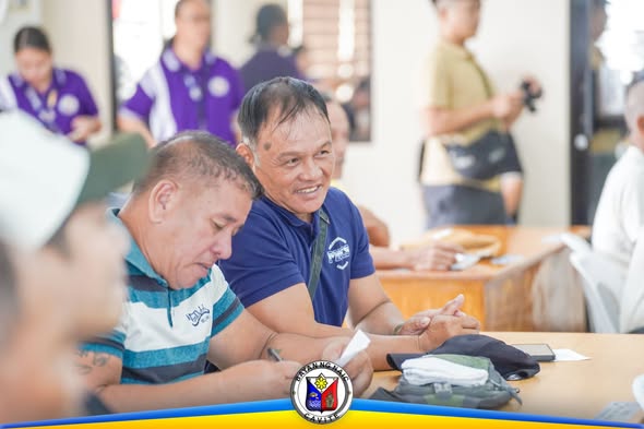 Mga kalahok ng IEC Campaign para sa Fisherfolk ng Naic habang nakaupo at nakikinig sa Liga ng mga Barangay Building