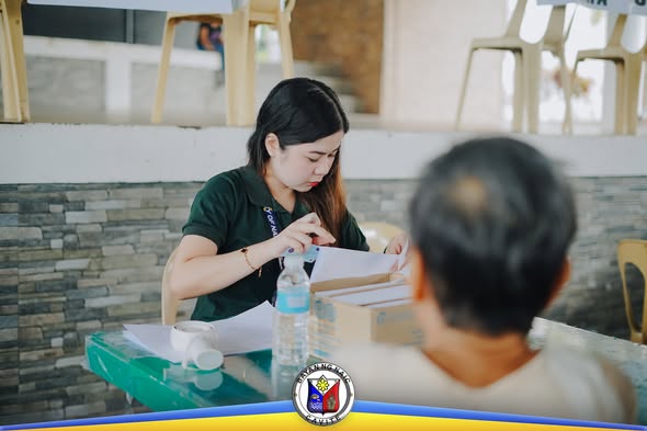Staff ng pamahalaan na nag-aasikaso ng papeles para sa social pension ng senior citizen sa Naic Town Plaza