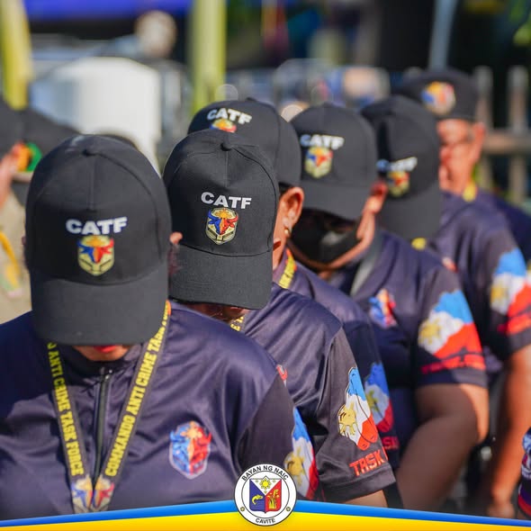 Mga miyembro ng CATF na naka-uniporme habang nakapila sa labas, bahagi ng seremonya sa Naic