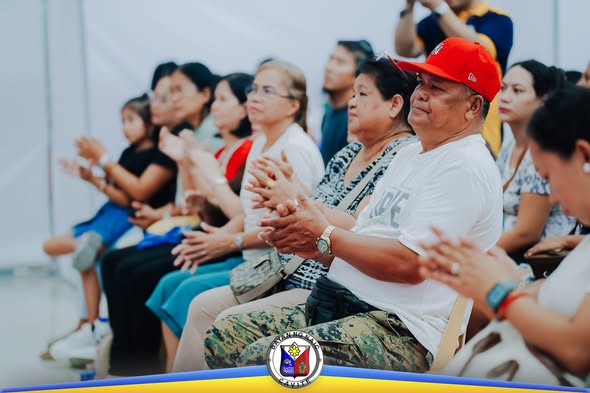 Mga dumalo sa pagpirma ng kasunduan na masigabong pumapalakpak sa Stadium Shopping Strip, Naic