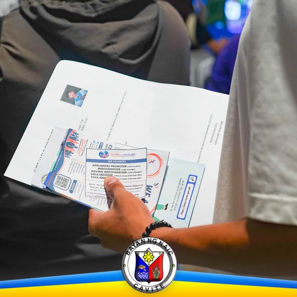 Mga flyer ng trabaho na hawak ng isang kalahok sa Job Fair 2026 sa Waltermart Naic