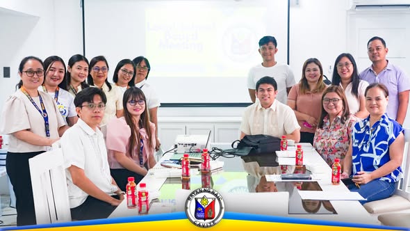 Grupo ng mga kalahok sa Local School Board Meeting sa Naic Municipal Hall, nakapalibot sa mahabang mesa habang may…