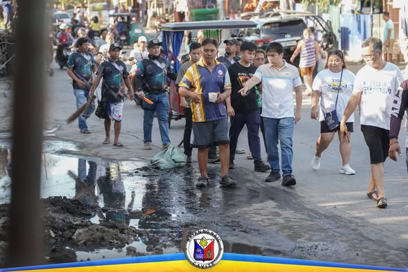 Mga residente at opisyal na naglalakad sa kalsada habang naglilinis sa Ciudad Nuevo Phase 3, Naic