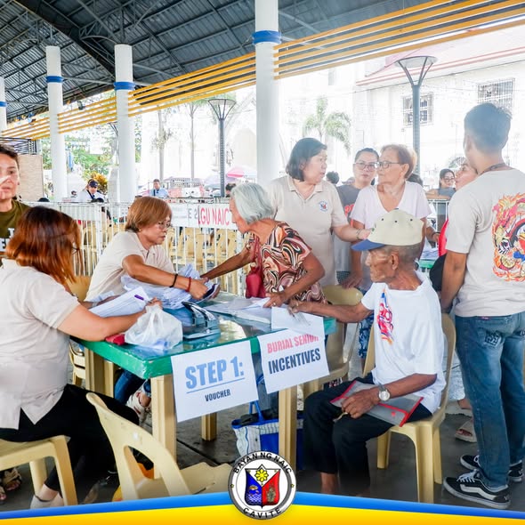 Pamamahagi ng burial assistance sa Naic Town Plaza, may mesa para sa Step 1: Voucher