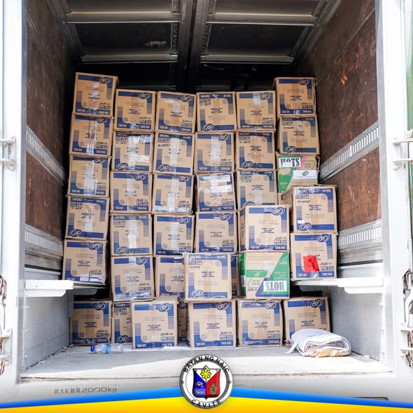 Mga karton ng school supplies na nakasalansan sa loob ng truck bago ipamahagi sa Naic Integrated National High School