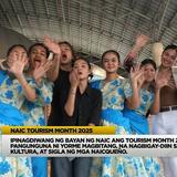 Mga performer na naka-floral na kasuotan habang kumakaway sa Tourism Month 2025 celebration sa Naic